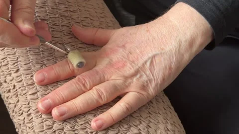 An unknown elderly woman makes herself a hand massage with her hand with a Stock Footage 301136215