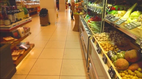 Unknown female customer chooses vegetables at the supermarket. 4K video 動画素材 73928987