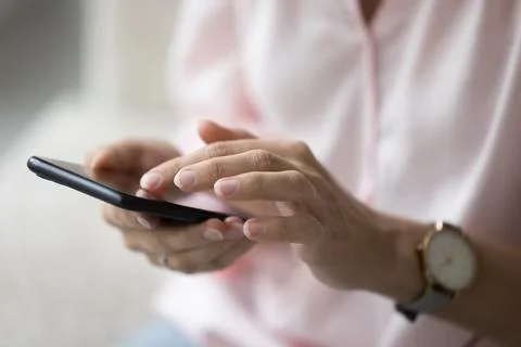 Unknown female using modern smart phone indoors, close up 스톡 사진