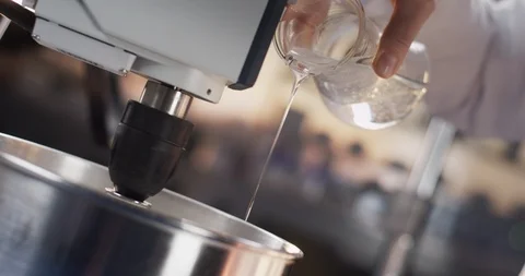 Unknown fluid dripping out of erlenmeyer flask into a metal bowl Stock Footage 105418903