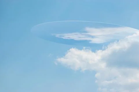 Unknown flying object silhouette hiding in blue sky Stock Illustration