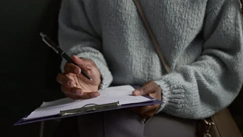 Unknown Girl Filling in Application Form Waiting for Appointment in Visa Office Stock Footage 311024600