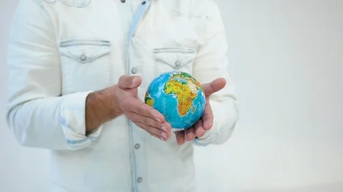 Unknown good-dressed man holding in his hands mockup of earth on the white Stock Footage 122171858