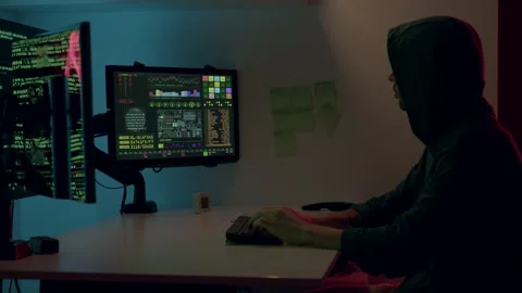 An unknown hacker in front of monitors and breaking secret data and information Stock Footage 313932877