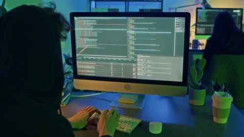 Unknown Hacker with Hood over Head Disrupting Services of Computer at Night Stock Footage 299272643
