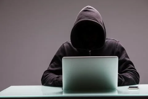 Unknown Hackers programmer using computer laptop for hack information and dat Stock Photos