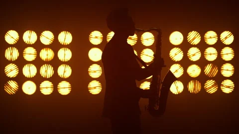 Unknown jazz man saxophonist performing on stage. Player holding modern sax. Stock Footage 180951408