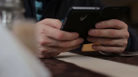 Unknown man chatting with mobile app cellphone in cafe Stock Footage 73616793
