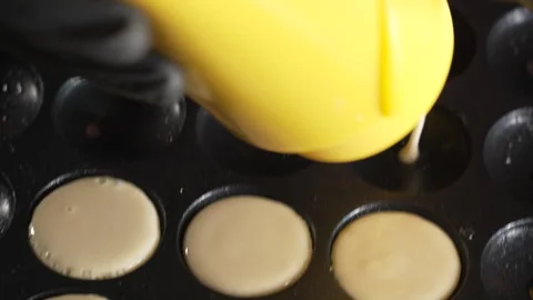 Unknown man chef preparing round pancakes on a hot surface Stock Footage 321054976