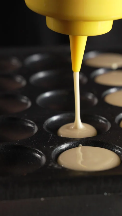 Unknown man chef preparing round pancakes on a hot surface Stock Footage 321055067
