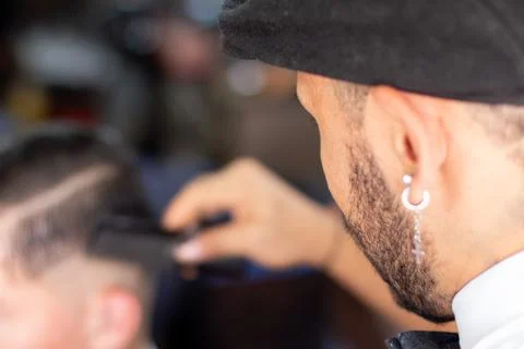 Unknown man combing his client's hair in a barber shop. Hair Stimulation growth Stock Photos