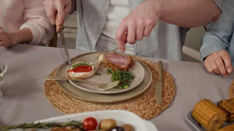Unknown Man Cutting and Serving Roasted Pork at Family Dinner Table Stock Footage 340335829