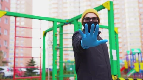Unknown man in face mask limits entrance to children playground outdoor close up Video stock 131477226