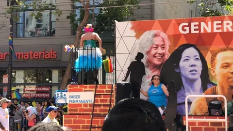 Unknown man with gay's flag on a car during San Francisco's LGBT pride parade Stock Footage 93868112