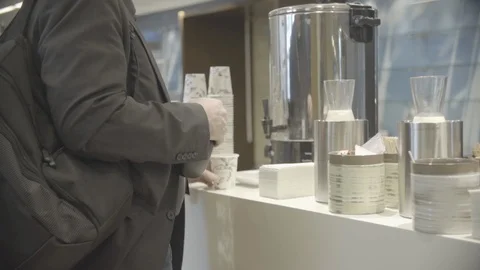 Unknown man getting coffee from urn Stock Footage 98765518