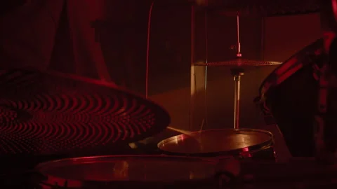 Unknown Man Hitting Snare Drum with Drumsticks in Red Lit Studio Stock Footage 338401791