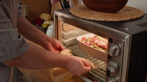 Unknown Man Putting Baking Dish with Meat Roast into Oven and Setting Timer Stock Footage 340328842