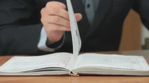 Unknown man reading a book. Close-up Stock Footage 87762547