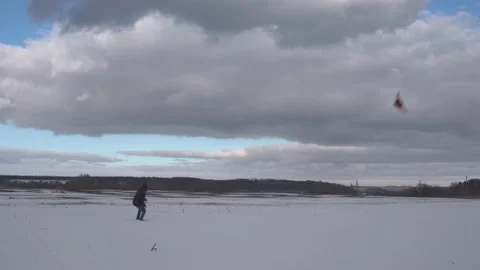 Unknown man skillfully controls a kite and draws an infinity sign with it Stock Footage 232724348