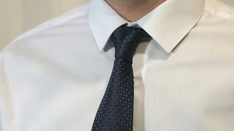 Unknown man tightening tie in front of camera Stock Footage 87677499