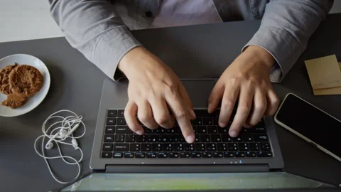 Unknown Man Typing on Laptop Keyboard Working Remotely at Office Desk Stock Footage 348139903