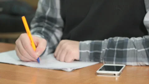 Unknown man writes text using pen in notebook Stock Footage 89975200