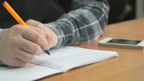 Unknown man writes text using pen in notebook Stock Footage 91924626