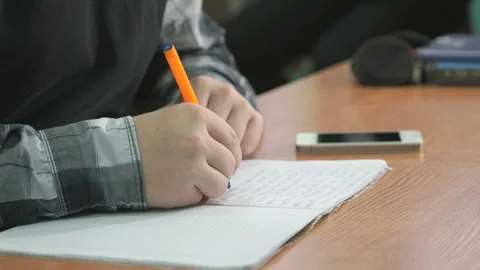 Unknown man writes text using pen in notebook Stock Footage 316792257