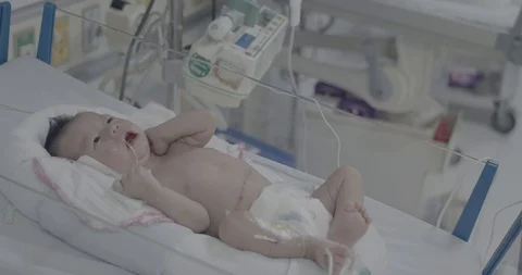 A unknown newborn baby crying in bed incubator Stock Footage 127743384