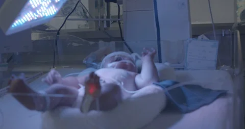 A unknown newborn baby crying in bed incubator Stock Footage 127743433