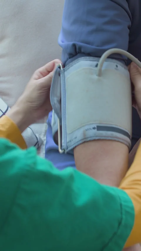 Unknown Nurse Placing Cuff of Blood Pressure Monitor on Elderly Patients Arm Video stock 298640885