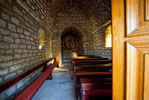 Unknown old lady praying in old church Stock Photos