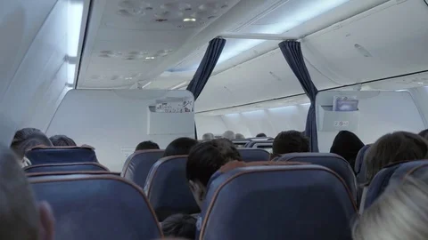 Unknown passengers sitting in the plane Stock Footage 84581566