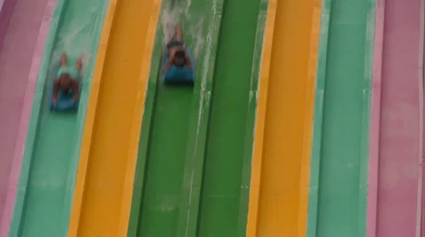 Unknown People Racing Down Multi-Colored Water Slides Video stock 24673950