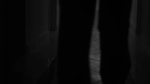 Unknown people walking down the hallway in the darkness Stock Footage 80221389