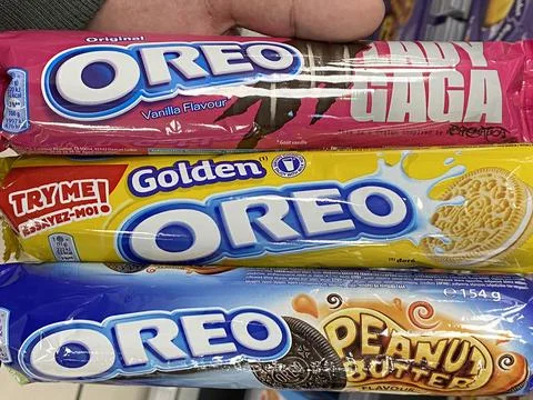 Unknown person holds three types of Oreo biscuits Stock Photos