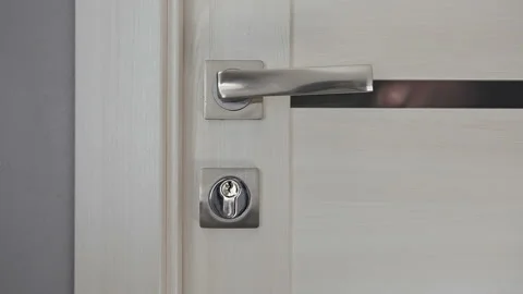 An unknown person knocks on the closed door and pulls the handle. video sound Video stock 237316283