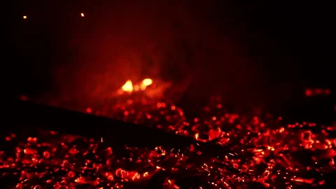 Unknown person moving the fire burning out.  Stock Footage 252698137