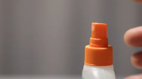 Unknown person pressing red spray button. Insecticide, mosquito repellent Stock Footage 124718980