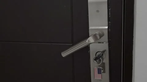 An unknown person tries to open the closed door on the back side to get into the Stock Footage 204990101