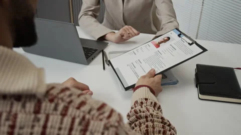 Unknown Recruiter Giving Application Form to Jobseeker after Interviewing Him Stock Footage 330518362