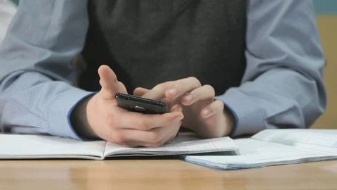 Unknown student holding black smartphone 스톡 동영상 84239475