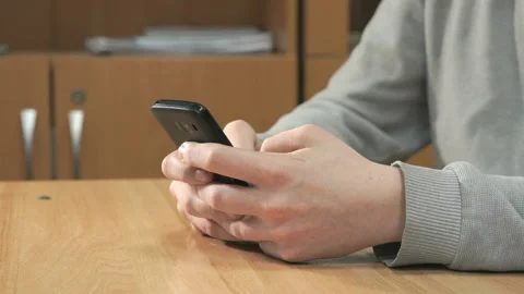 Unknown student holding black smartphone Stock Footage 87573249