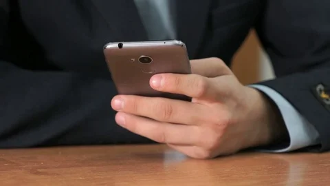 Unknown student holding grey smartphone Stock Footage 82956612