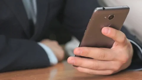 Unknown student holding grey smartphone Stock Footage 82956650