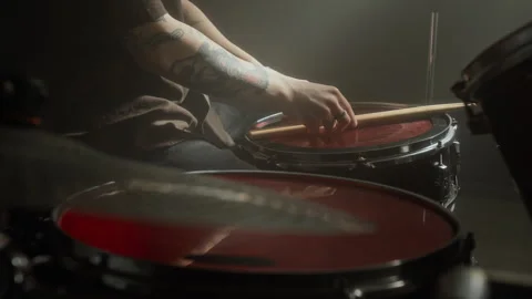 Unknown Tattooed Man Resting Drumsticks on Snare Drum during Rehearsal Stock Footage 338397016