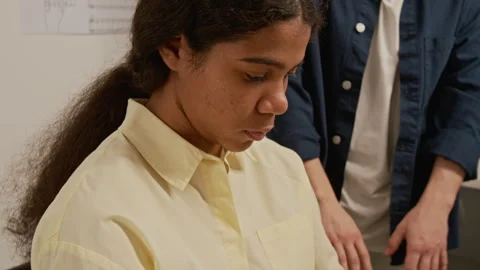 Unknown Teacher Correcting Posture of Girl Learning to Play Musical Instrument Stock Footage 339191180
