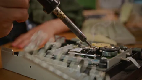 Unknown Technician Repairing Vintage Computer Hardware Using Soldering Iron Stock Footage 341424762