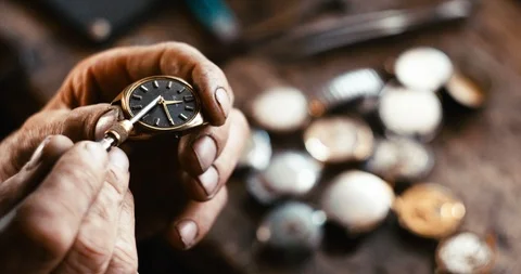 The unknown watchmaker is fixing the ancient vintage hand watch in his workshop Stock Footage 93140866