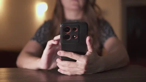 Unknown woman is using her smartphone at home Stock Footage 329823722